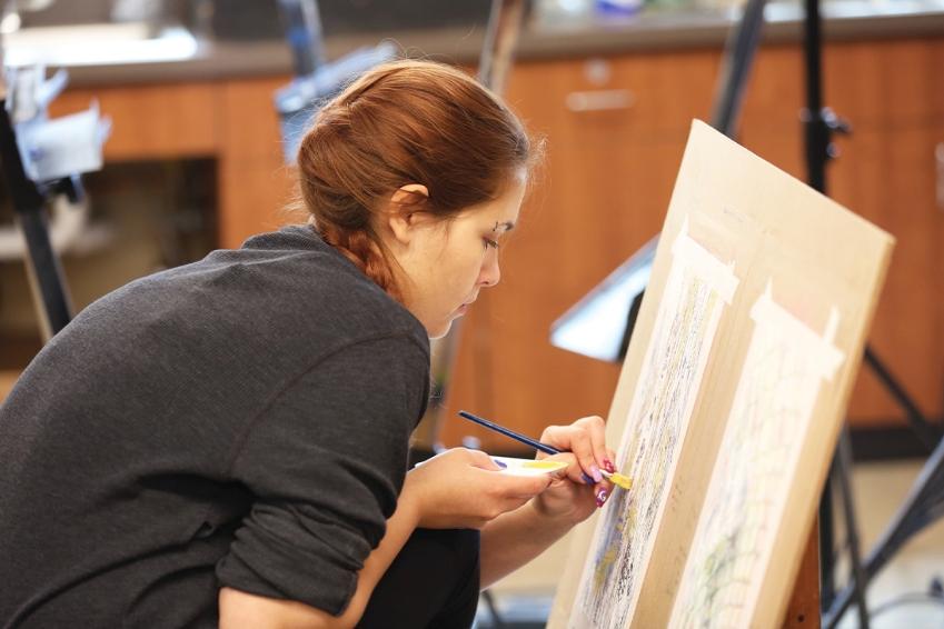 Art student painting in studio